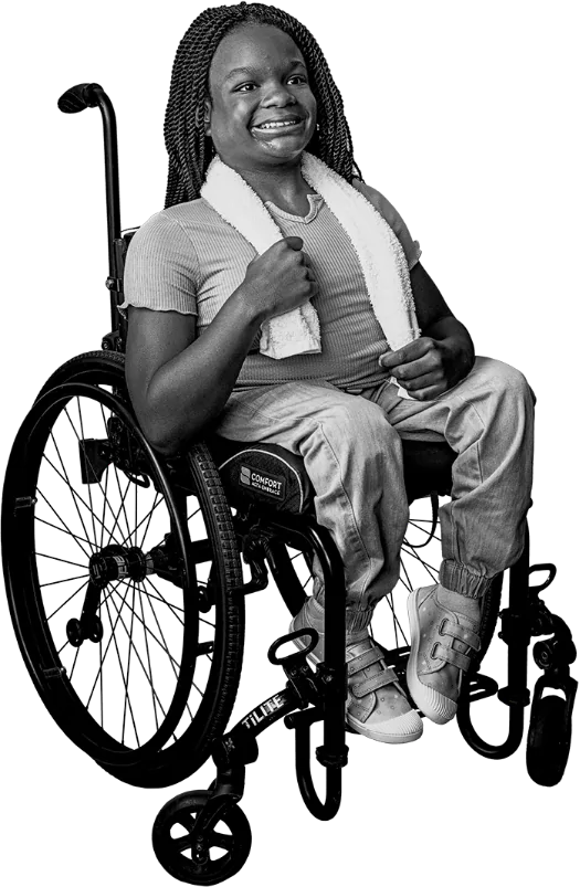 Mia, a patient with pediatric chronic sialorrhea, sitting in a wheelchair talking about XEOMIN